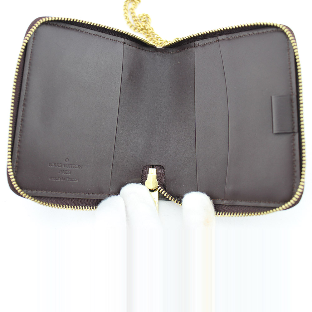 Porte-monnaie Zippy / Porte-cartes Louis Vuitton Authentique d'occasion en cuir vernis couleur Amarante avec chaîne métallique